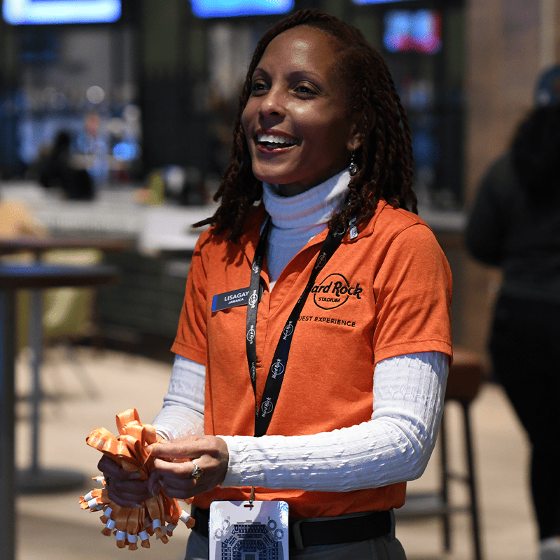 A Guest Experience Employee Holds wristbands at Hard Rock Stadium
