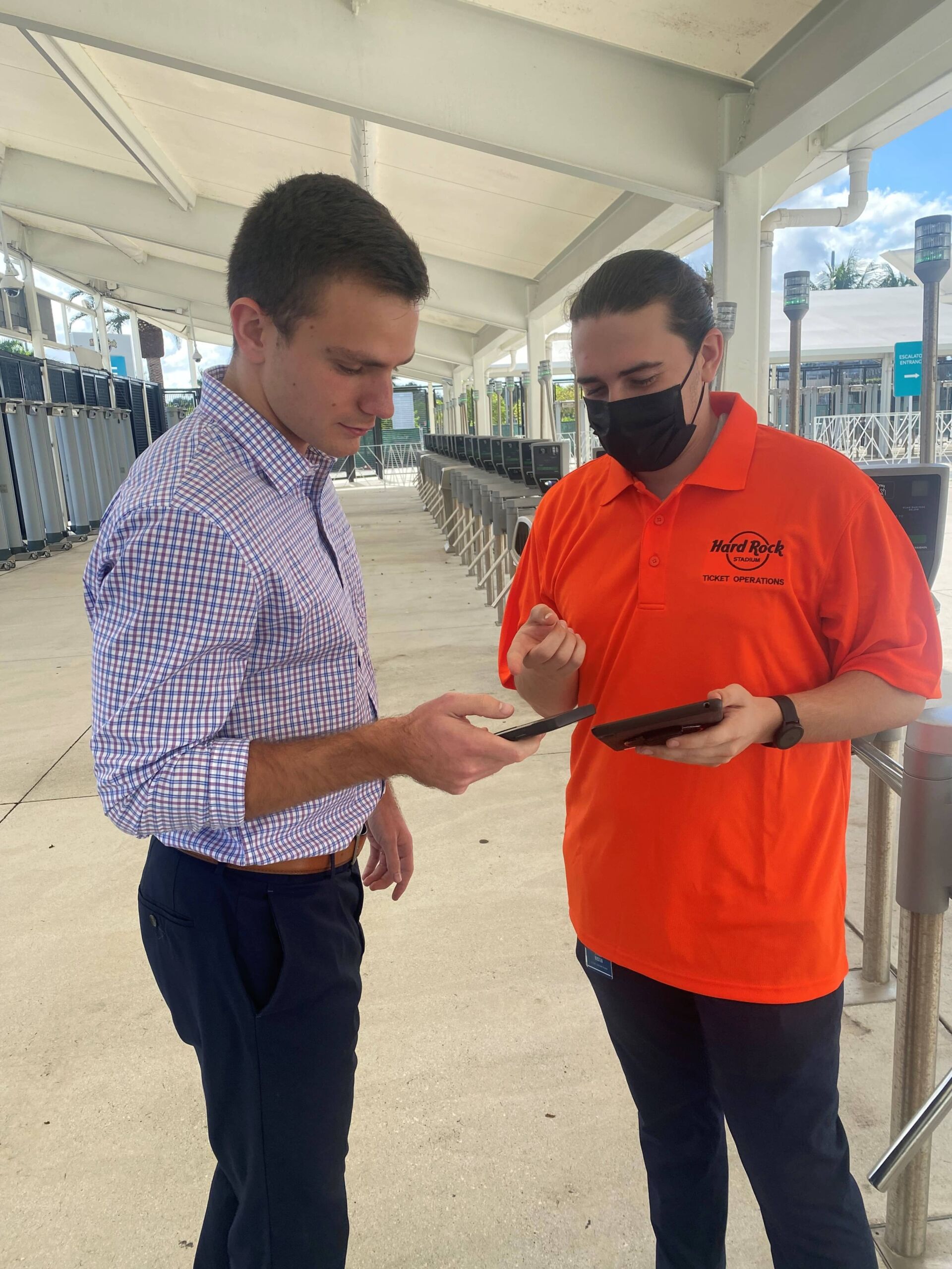 IMAGE of two box office workers scanning tickets at Hard Rock Stadium